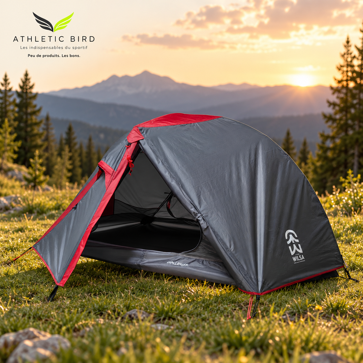 Tente Challenger grise et rouge installée dans une clairière face aux montagnes au coucher du soleil, avec logo Athletic Bird